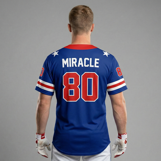 Back view of a blue jersey with Miracle 80 printed in red and white on a grey background