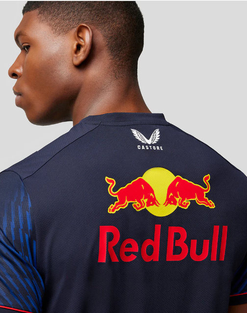 Man wearing dark blue Red Bull Castore jersey showing back logo