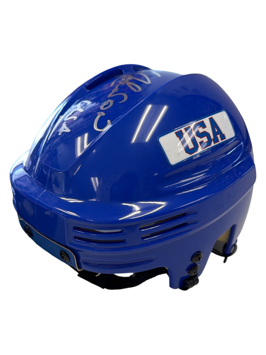 Blue USA hockey helmet with white sticker and signature