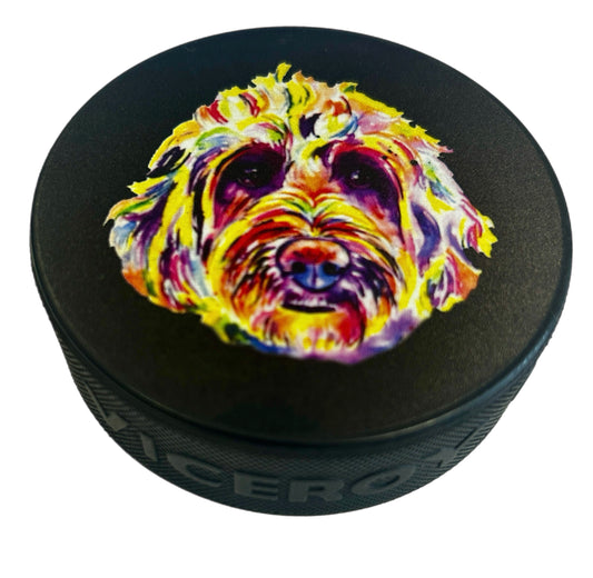 Black hockey puck with a colorful artistic doodle dog portrait