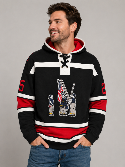 Man wearing a black hockey style hoodie with a firefighter graphic and American flag
