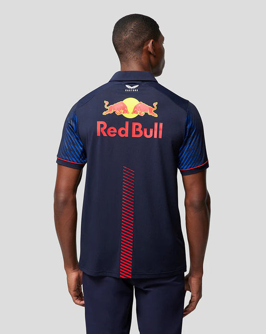 Back view of a person wearing a navy blue Red Bull polo shirt with red accents and Castore branding
