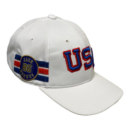 A white baseball cap featuring embroidered 'USA' in red and blue on the front and a circular 'Back 86 Winners' patch on the side.