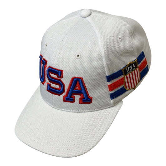 A white baseball cap featuring 'USA' embroidered in blue with a red outline on the front, and a USA flag-themed patch on the side.