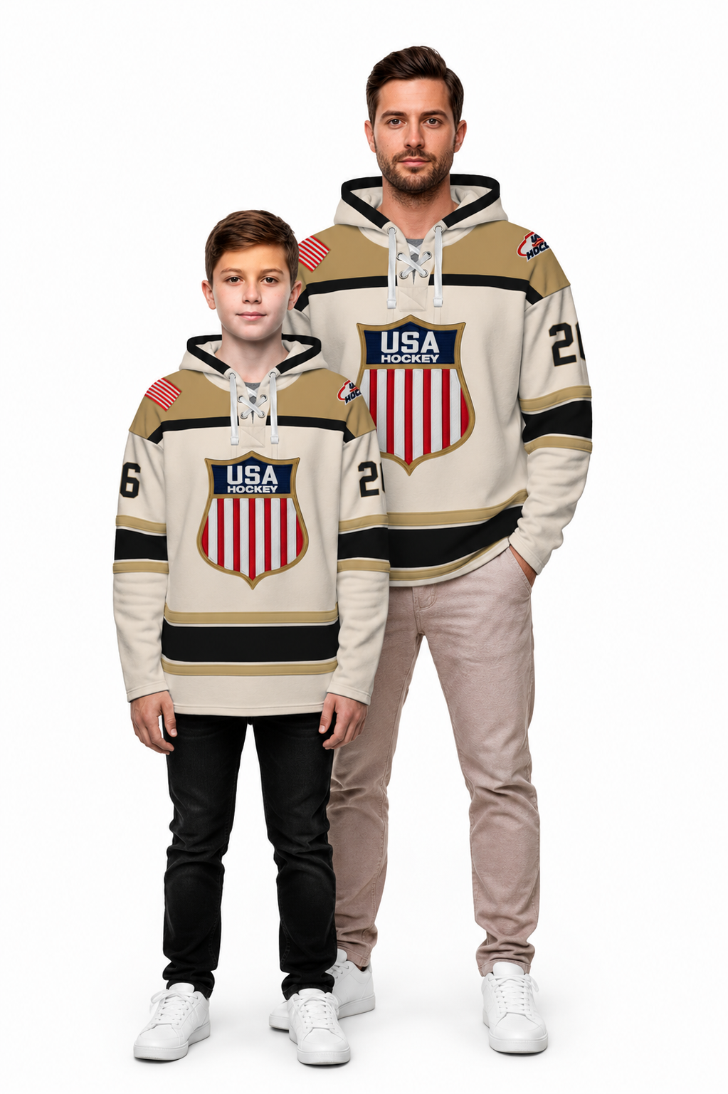 A man and a boy modeling matching beige and black USA hockey-themed hoodies against a plain white background.