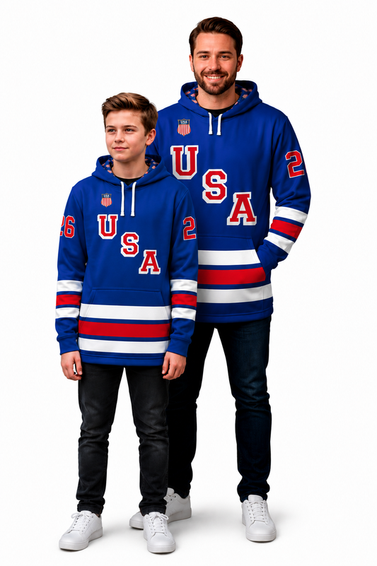 Man wearing a blue USA hockey hoodie with red and white stripes and the number 62 on the sleeves with a young man wearing a blue USA hockey hoodie with red and white stripes and number 26 on the sleeves in front of a man