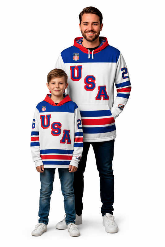 Man wearing a white USA Hockey hoodie with blue and red stripes and the number 62 on the sleeves with boy wearing a white USA hockey hoodie with red and blue stripes and jeans in front of the man