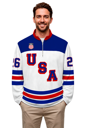 Man wearing a white USA hockey quarter zip pullover with red and blue accents