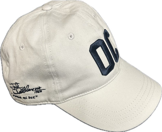 Off white baseball cap with navy blue embroidered letters on the front and script text on the side
